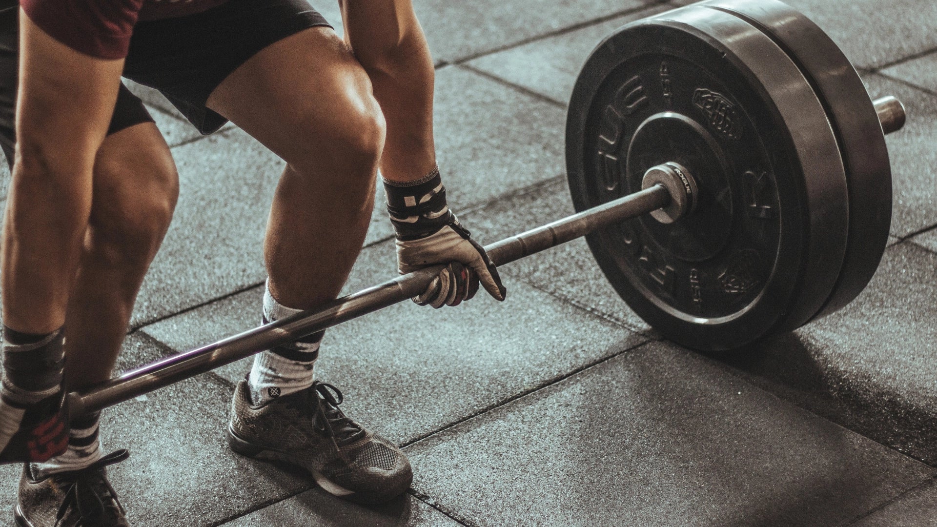 A man at the gym lifting some weights